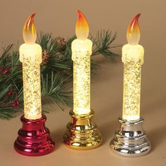 three lighted candles sitting next to each other