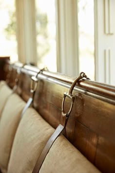 the back of a couch with leather straps on it