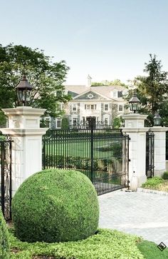 a large white house with an iron gate