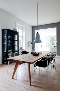 a dining room table and chairs in front of a bookcase