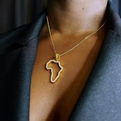 A statement necklace to elevate your style. Elegantly showcase the motherland with this sparkling Africa outline pendant guaranteed to attract attention. Dimensions Large Pendant: Width: 2.3cm/ Height: 3cm Small Pendant: Width: 1.1cm/ Height: 1.2cm Chain Length: 45cm + 5cm extension chain Material 18k Gold Plated  Brass Metal Base Gold, of at least 2.5 microns, is layered on top of a brass base to create a finish five times thicker than average gold plating, and far more durable. Expertly plated Africa Outline, Africa Pendant, Africa Jewelry, Africa Necklace, Map Necklace, Africa Map, Pendant With Chain, Small Pendant, Brass Metal