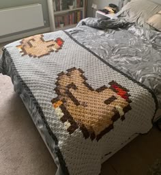 a bed with a dog afghan on top of it