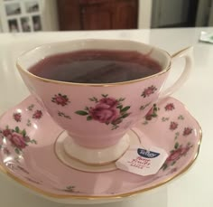 a pink tea cup and saucer on a white counter top with a price tag