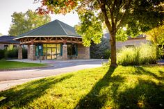 the building has a green roof and is surrounded by trees