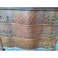 an old wooden dresser with metal handles