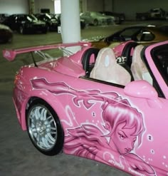 a pink car with an image of a woman on it