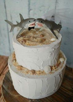 two tiered wedding cake decorated with shark and starfish on top of each other