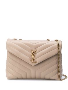 Saint Laurent shoulder bag in chevron-quilted leather. Chain and leather shoulder straps. Flap top with snap closure. Exterior, metallic YSL logo medallion. Interior, zip pocket. Made in Italy. Mochila Chanel, Sac Yves Saint Laurent, Pochette Louis Vuitton, Lou Lou, Luxury Purses, Van Cleef Arpels, Saint Laurent Bag, Womens Purses, Quilted Leather