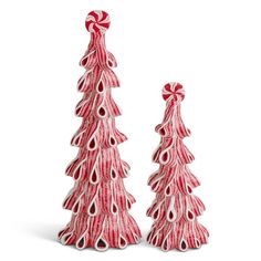 two red and white ceramic christmas trees with bows on each one's head, set against a white background