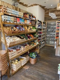 a store filled with lots of shelves and baskets full of food next to each other