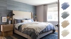 a bedroom with blue and white decor on the walls, carpeted flooring and bedding