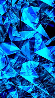 an abstract blue background consisting of many shiny pieces of tin foil and plastic wrappers