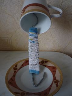 a spool of thread is attached to a saucer