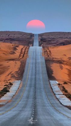 the sun is setting over an empty road in the middle of nowhere, with no cars on it