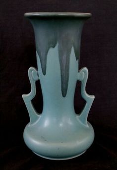 a large blue vase sitting on top of a table