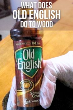 an old english bottle is being held by someone's hand with the caption, what does old english do to wood?