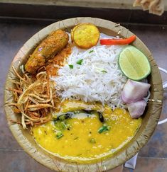 a bowl filled with rice, meat and veggies on top of a table