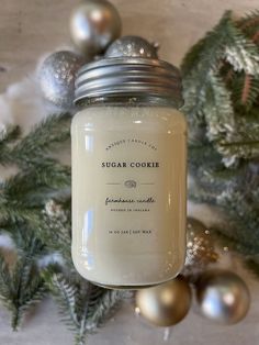 a glass jar filled with sugar next to christmas decorations