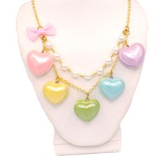 "A cute and sweet statement necklace for Valentine's Day or lovecore season! This kawaii charm necklace includes Five heart shaped macaron ( macaroon ) pendants in pastel shades with a pearly finish and whipped cream center. Each necklace includes five 1\" (2.5 cm) size charms hanging on a two-layered chain necklace with glass pearls on your choice of a 21\" gold plated or silver plated chain. Accented with a baby pink fabric ribbon bow on one side. Necklace will be finished with a Fatally Feminine Designs engraved heart charm. Closes with a lobster clasp. **Made to order - please allow 2 weeks for your item to be made before shipment** Matching Earrings and rings in my shop: https://etsy.com/shop/fatallyfeminine Every order comes with free gift packaging. Please contact me with any questi Kawaii Necklaces For Valentine's Day, Kawaii Style Necklaces For Valentine's Day Gift, Cute Multicolor Charm Necklaces, Cute White Necklace With Heart Charm, Cute Pastel Jewelry For Gifts, Cute Pastel Jewelry For Gift, Sweet Heart-shaped Necklace For Valentine's Day, Cute Multicolor Charm Necklaces For Valentine's Day, Cute Multicolor Charm Necklace For Valentine's Day