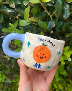 model holding white mug with periwinkle handle with 'yee-haw' orange on it Ceramic Food, Orange Mugs, Pinch Pot, Long Night, Hand Painted Mugs, Painted Mugs