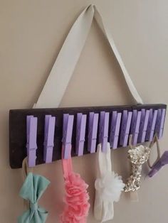 a wall hanging with several different types of hair clips attached to the side of it