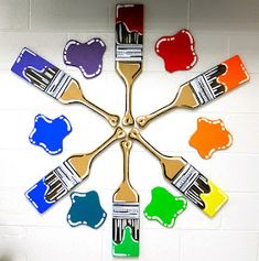 a clock with paint brushes painted on it