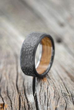 a wooden ring sitting on top of a piece of wood