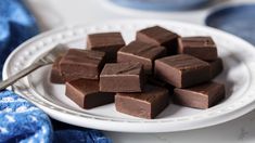 a white plate topped with pieces of chocolate