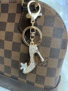 a handbag with a key chain attached to it