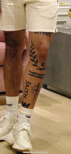 a man's legs with tattoos on them