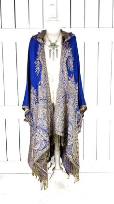 Hooded blue floral paisley pashmina kimono cover up jacket with custom length and fringe detail Measurements...taken flat - width across seam to seam: 46"  - regular length with 4" fringe: 38" (in photo) Features... - lovely soft woven medium weigh pashmina fabric - bohemian oversized flowing design - cardigan style with an open front and generous arm holes  - attached hood - universal design allows a comfortable fit for small through plus sizes -customize your length and fringe detail - the perfect layering piece that can easily be dressed up or down - wrinkle resistant  - handmade with love by me in California Blue Bohemian Shawl For Spring, Fitted Bohemian Outerwear With Tassels, Blue Tasseled Outerwear For Fall, Bohemian Blue Pashmina Shawl With Paisley Print, Bohemian Blue Paisley Print Pashmina Shawl, Bohemian Blue Paisley Pashmina Shawl, Festive Blue Bohemian Pashmina Shawl, Blue Fall Shawl, Blue Bohemian Shawl Wrap