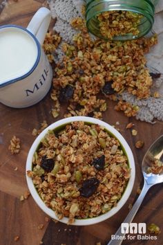 a bowl of granola next to a cup of milk