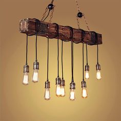 a light fixture made out of wood and hanging from the ceiling with lights on it