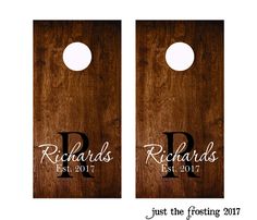 two wooden door hangers with initials and date printed on the front one has a hole in the middle