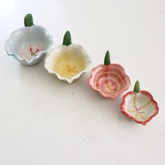 three flower shaped bowls sitting on top of a table