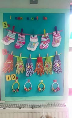 there are many pairs of socks hanging on the clothesline with numbers and letters attached to them