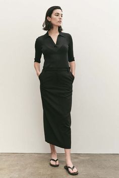 Mijeong park split back midi skirt in black lightweight suiting fabric.    60% polyester 32% rayon 8% polyurethane.    model wears size small. model is 5’ 9”. fits true to size.    measurements:    - waist : xs-27” s-28 3/4” m-30 1/2” l-32”  - hip : xs-36 1/2” s-38 1/2” m-40 1/2” l-42 1/2”  - length : xs-35 1/2” s-36” m-36 1/4” l-36 1/2”    made in china. Mijeong Park, Suiting Fabric, Caged Sandals, Black Tank Dress, Black Aviators, Neon Purple, Black Midi Skirt, Best Clothing, Ruched Dress