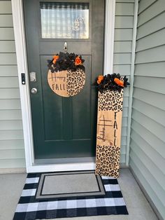 two leopard print pumpkins are on the front door