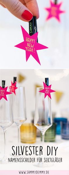 a person holding a wine bottle in front of three glasses with pink stars on them