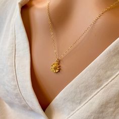 A beautiful small, shiny gold flower with lots of detail is hung on a delicate yet sturdy 14K Gold-Filled Chain. Sweet and simple. Feminine and charming. - Pendant - 14k Gold plated Brass - 9mm in diameter - Chain + components - 14K Gold-Filled - Clasp - 14K Gold-Filled lobster clasp . . . . . . . . . . . . . . . . . . . . . . . . . . . . . . . .  Want more for bridesmaids, sisters or friends? I am happy to put custom orders together! . . . . . . . . . . . . . . . . . . . . . . . . . . . . . . . .  Necklace arrives packaged for giving. Dainty Flower Charm Necklace For Wedding, Elegant Gold Flower Charm Necklace, Delicate Flower Charm Necklace With Delicate Chain, Gold Flower Pendant Necklace For Anniversary, Gold Flower Necklace In 14k Gold, Delicate Yellow Gold Flower Necklace, Delicate Gold Flower Necklace For Gift, Delicate Gold Flower Necklace As Gift, Yellow Gold Flower Charm Necklace