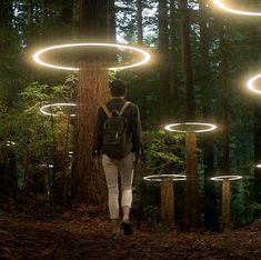 a man with a backpack walks through the woods in front of glowing circles on trees