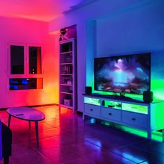 a living room filled with furniture and colorful lights on the wall behind it is a flat screen tv