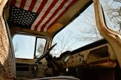 an old truck with the american flag on it's side window and door open