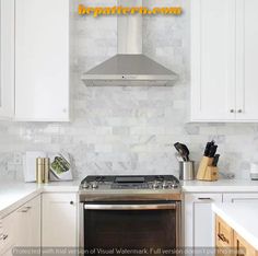 a stove top oven sitting inside of a kitchen next to white cupboards and counter tops