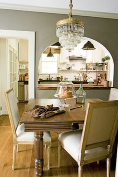 a dining room table with chairs and a chandelier