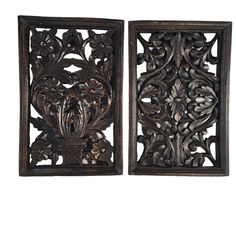 two carved wooden panels with flowers and leaves