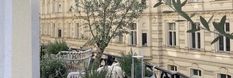 there is a tree in the middle of an apartment building with balcony railings and balconies