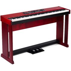 a red piano sitting on top of a black stand