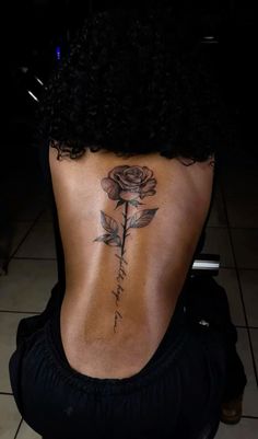 a woman with a rose tattoo on her back