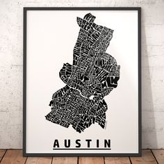 a black and white map of the city of austin, texas on a wooden floor